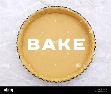 Flan tin lined with shortcrust pastry - BAKE text Stock Photo - Alamy