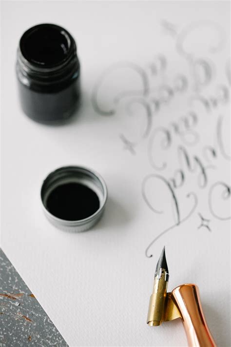 Black Ink in a Bottle and a Calligraphy Pen · Free Stock Photo