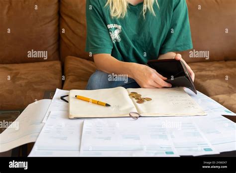 Blonde Girl With Financial Problems Girl Doing Taxes Bills And Invoices On The Table