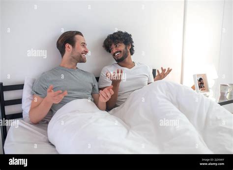Gay Couple Talking To Each Other In Their Bedroom Stock Photo Alamy