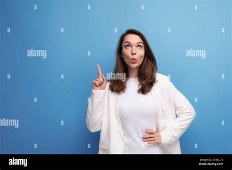 Happy Lucky Brunette Woman In Ivory Jacket And White Dress On Purple Background With Copy Space