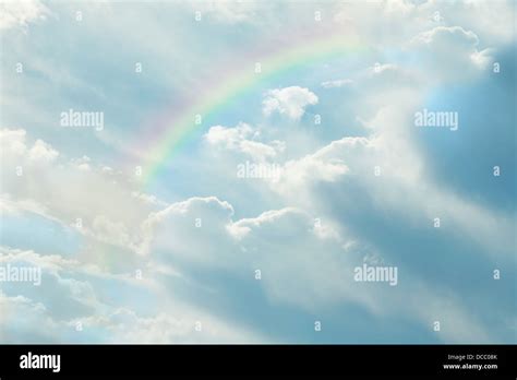 Beautiful clouds in blue sky with rainbow Stock Photo - Alamy