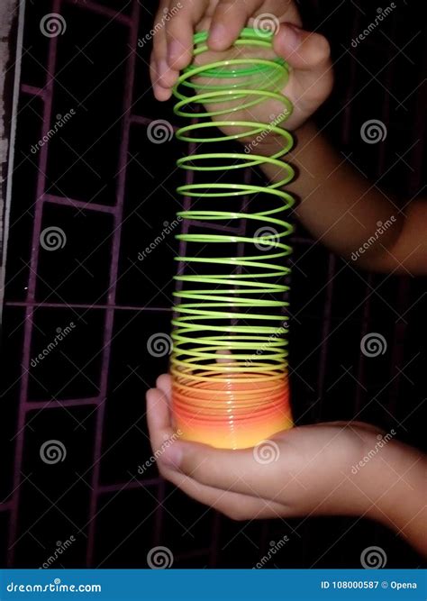 Human Hand Holding Slinky Toy