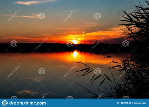 Bright Beautiful Red Orange Sunset With Reflection In The Evening Over