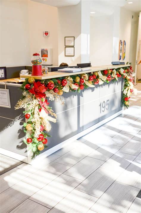 Receptionist Desk Decorated With Christmas Garland Office Lobby