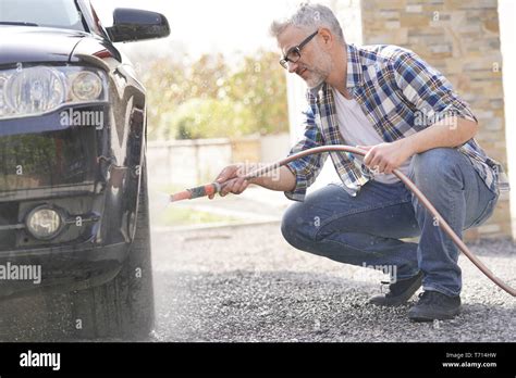 Mature Man Washing His Car In Driveway Stock Photo Alamy