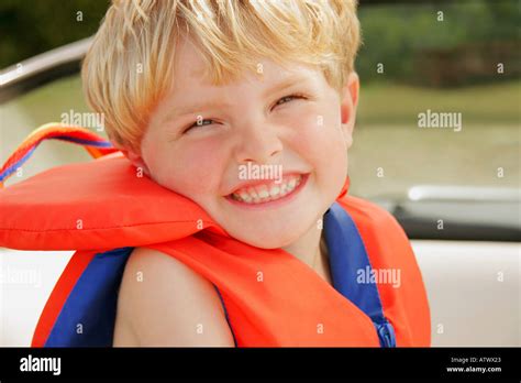 A Happy Little Boy Wearing A Life Jacket Stock Photo Alamy