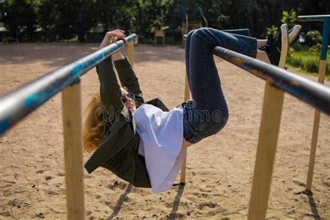 Cute Blonde Teenager Girl Playing In Park Playground Stock Photo
