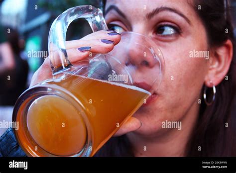 Brunette Woman Drinks A Nice Fresh Pint Of Blonde Beer In A Glass Mug In Germany Stock Photo Alamy
