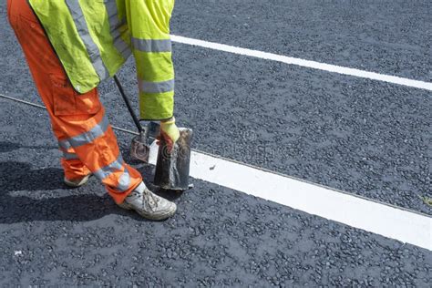 Road Workers Applying Hot Melt Traffic Resistant Paint For White