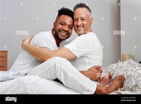Happy Gay Couple Embracing On Bed At Home Stock Photo Alamy