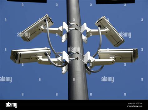 Security cameras in use in a shopping mall parking lot Stock Photo - Alamy