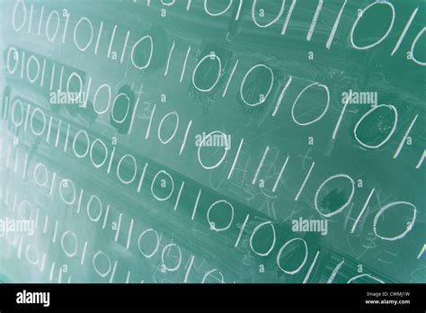 Binary code on blackboard Stock Photo - Alamy