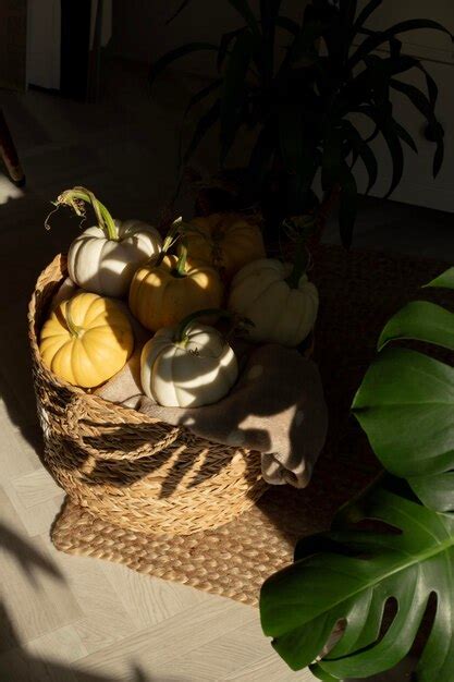 Premium Photo Cozy Still Life With Pumpkins Lying In A Wicker Basket