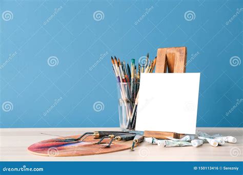 Set of Painting Tools with Canvas on Table Against Color Background ...