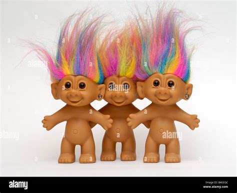 A Trio Of Naked Troll Dolls With Brightly Colored Hair Stand In A Row Trolls Of This Type Were