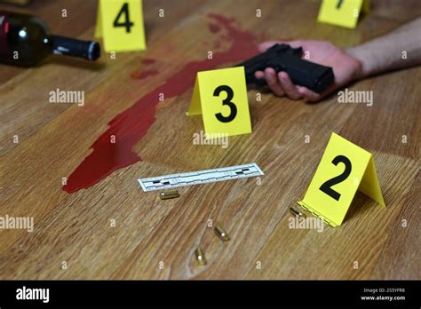 Bloody crime scene with dead body and gun on floor. Many crime scene ...