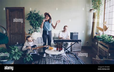 Pretty Blonde Vocalist From Popular Musical Band Is Singing And Dancing While Her Friends