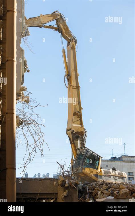 closeup  destruction  building  hydraulic excavatorcutter