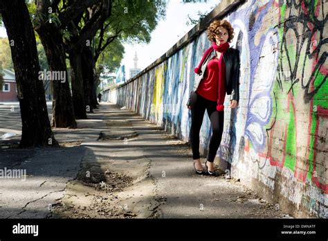 Gorgeous Brunette Woman Posing With Graffiti On The Street Stock Photo Alamy