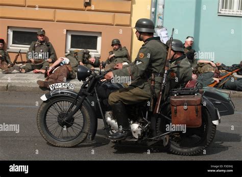 Reenactors Uniformed As German Nazi Soldiers Ride A Motorcycle During