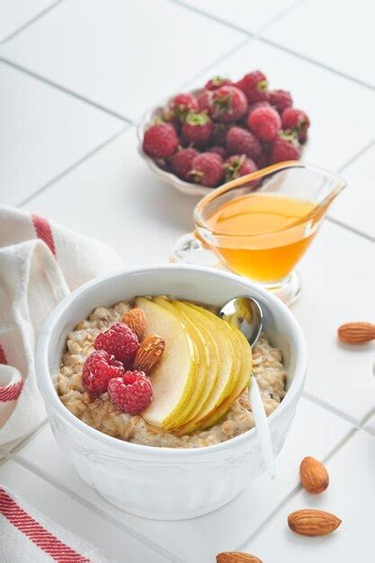 Premium Photo Oatmeal Bowl Of Oatmeal Porridge With Raspberry Pear