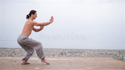 Caucasian Man With Naked Torso Practicing Wushu On The Seashore Stock Photo Image Of Fitness