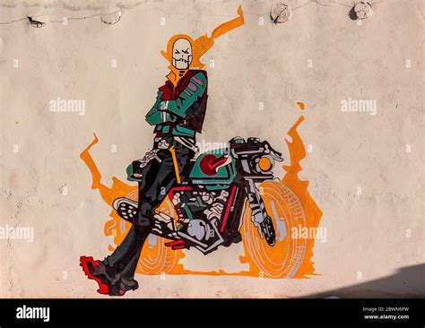 Graffiti of ghost rider with his bike on a wall of a cafe in Ladakh ...