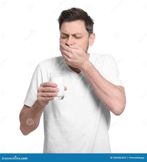Man with Glass of Milk Suffering from Lactose Intolerance on White