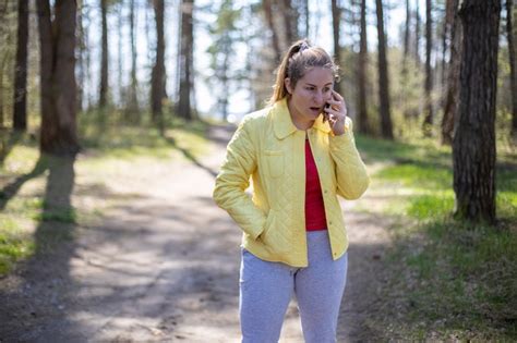 Premium Photo Woman Is Emotionally Talking On The Phone In The Forest