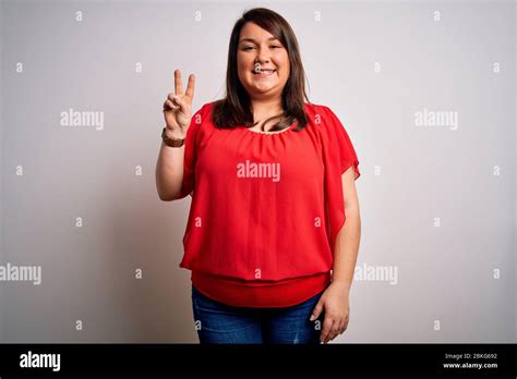 Beautiful Brunette Plus Size Woman Wearing Casual Red T Shirt Over Isolated White Background