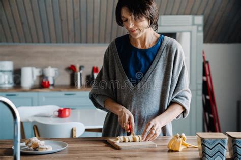 White Mature Woman Smiling While Making Breakfast In Kitchen Stock Image Image Of Kitchen