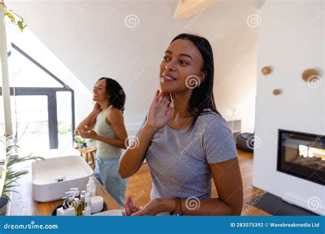 Happy Biracial Lesbian Couple Looking In Mirrors In Bathroom Stock Photo Image Of Adult