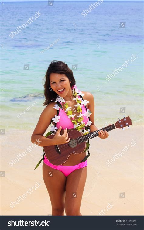 Beautiful Polynesian Girl With Flower Lei In A Pink Bikini Standing On A Secluded Hawaii Beach