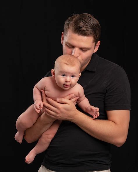 Premium Photo Dad Holds A Naked Baby In His Arms And Gently Kisses Father S Love And Care