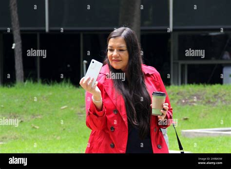 Year Old Latina Woman Walks In The Park While Drinking Coffee And