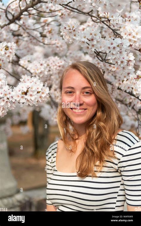 Tourist Young Woman In Front Of Blossoming Cherry Blossoms Japanese