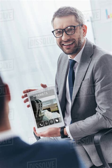 Smiling Businessman In Eyeglasses Holding Digital Tablet With Online