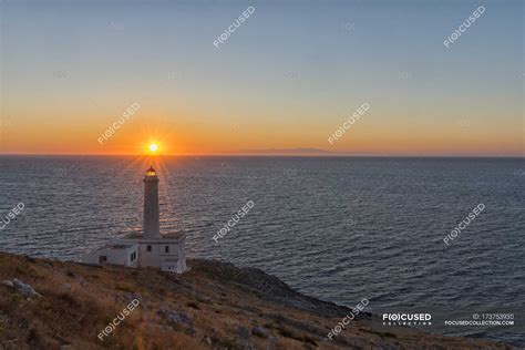 Sunrise over lighthouse — water, morning sky - Stock Photo | #173753930