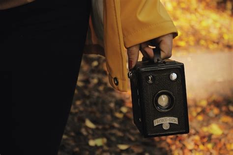 Premium Photo Midsection Of Woman Holding Old Camera
