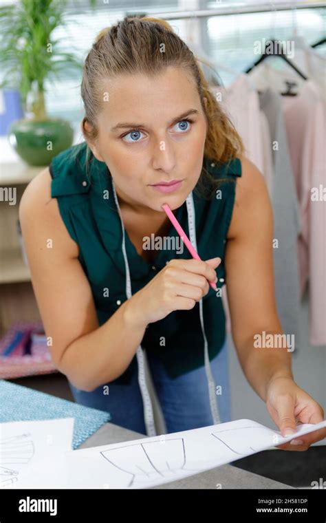 A Meticulous Seamstress Observing Her Blueprint Stock Photo Alamy