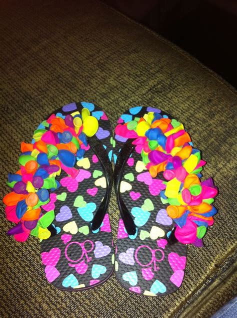 A Pair Of Colorful Flip Flops With Hearts On Them