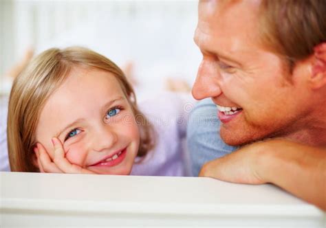 Smiling Mature Man Looking At His Innocent Daughter Closeup Of A Smiling Mature Man Looking At