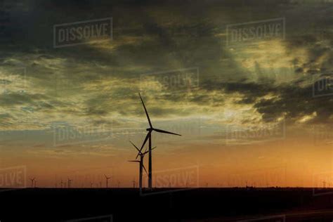 Wind Turbine Farms In The Colorful Sunset Showing Renewable Energy Works Wind Energy Blows Into