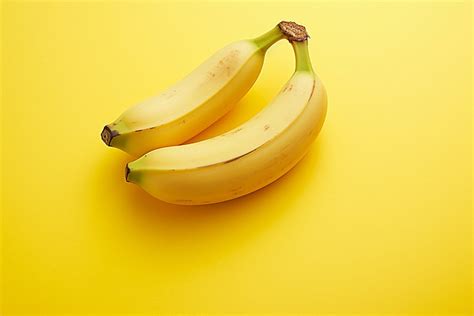 Two Bananas On A Light Yellow Background A Picture Of Banana Banana Fruit Background Image