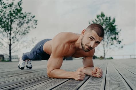Premium Photo Handsome Muscular Man With Naked Torso Outdoors Doing Fitness Workout