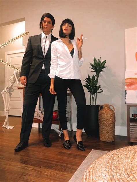 A Man And Woman Dressed In Business Attire Standing Next To Each Other