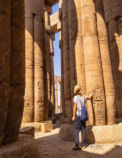Premium Photo | A young tourist in a white tshirt and hat looking at