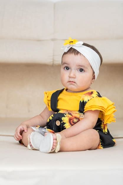Premium Photo Baby Latina Sitting On The Sofa With Her Sad Look Bored Because Her Mother Is