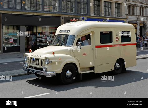 Old preserved City of Birmingham Bedford ambulance driving along the Strand in London Stock ...